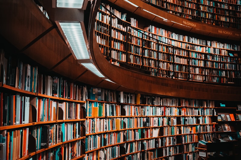 Curved shelves of books inside a large public library.
